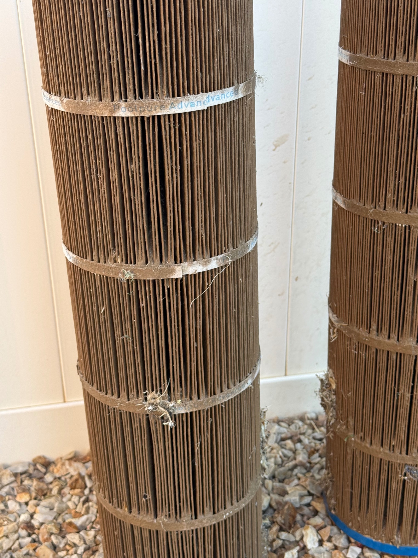 Close-up of pool filter pleats caked with desert dust